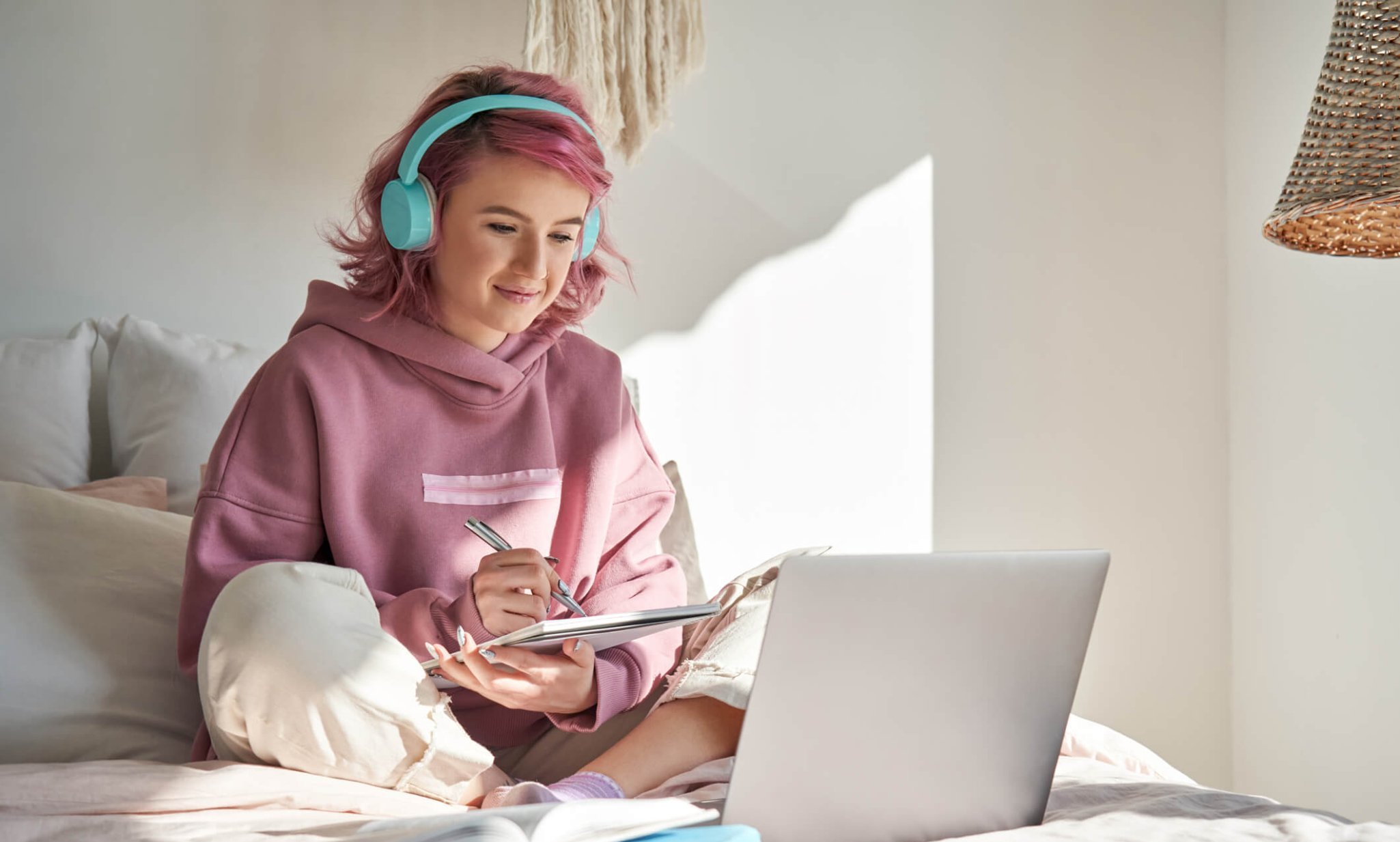 Hipster teen girl student with pink hair watch online webinar learning about Recovery-Oriented Language.